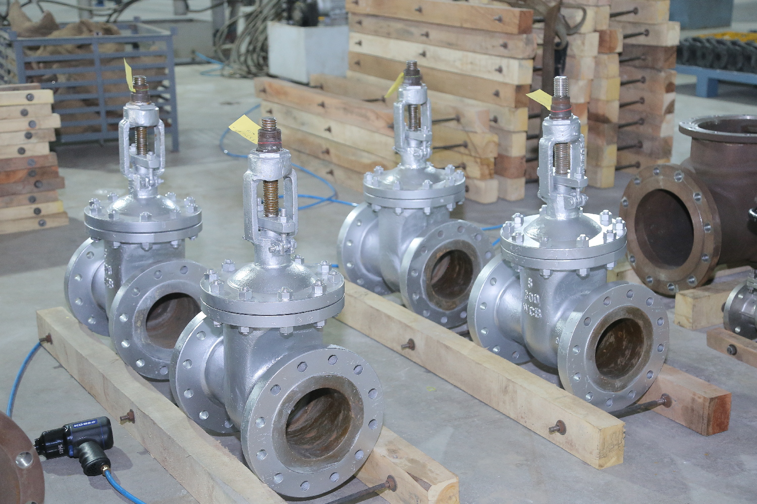 A collection of various industrial valves including metal and plastic types.